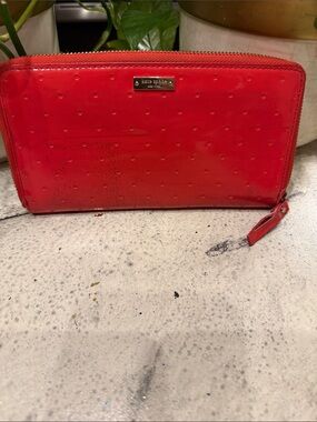 kate spade glossy orangey red zip-around wallet with dot embossing